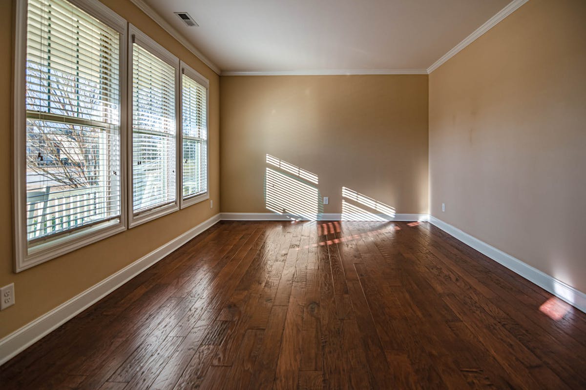 Sunlit room with hardwood floors protected by UV blocking film