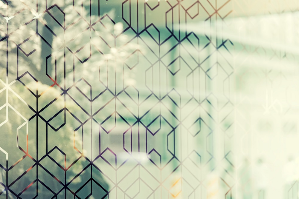 Reflection of tree in glass with decorative window film. Vintage filtered.