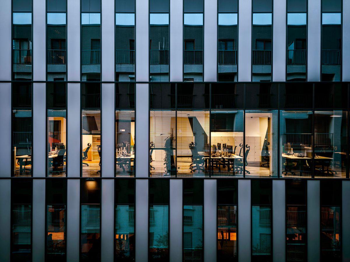 Office building facade with lit windows at dusk